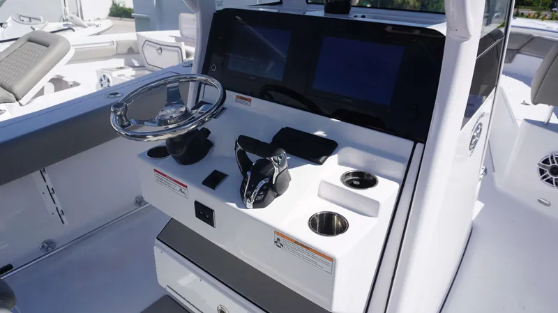 Slide: The Image of 2025 Sportsman 261 Heritage boat console with steering wheel and controls. - 15