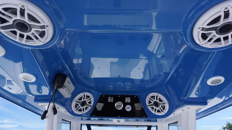 Slide: The Image of 2025 Sportsman 261 Heritage boat interior with blue ceiling and audio system. - 17