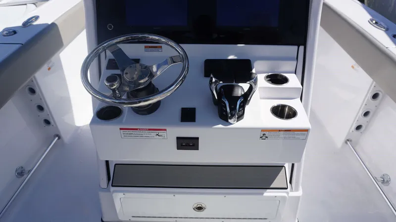 Slide: The Image of 2025 Sportsman 261 Heritage boat console with steering wheel and controls. - 18
