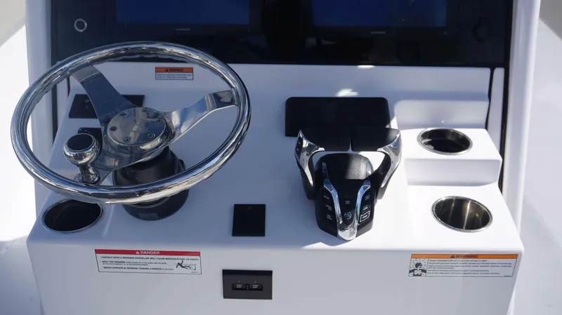 Slide: The Image of 2025 Sportsman 261 Heritage boat console with steering wheel and controls. - 19