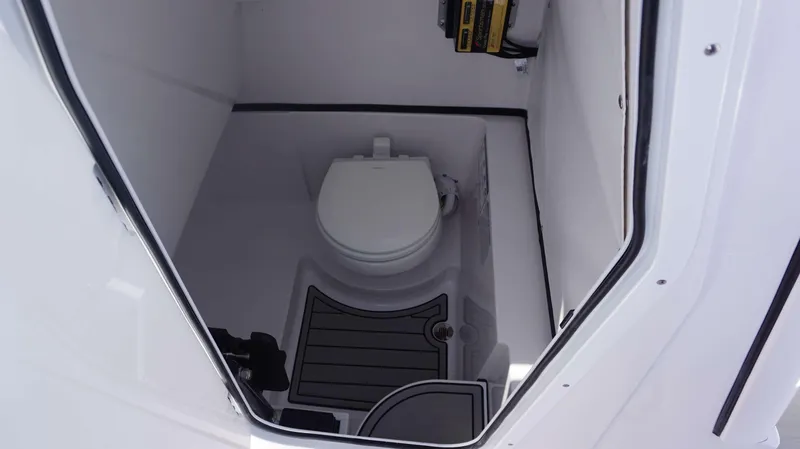 Slide: The Image of 2025 Sportsman 261 Heritage boat interior with compact marine toilet. - 23