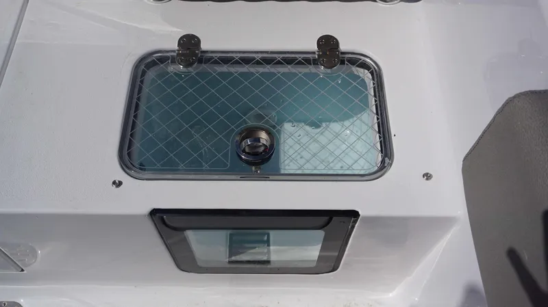 Slide: The Image of Livewell on 2025 Sportsman 261 Heritage boat, featuring a secure lid and clear viewing window. - 24