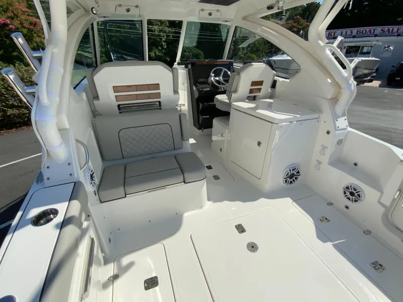 Slide: The Image of 2025 Pursuit DC 306 Dual Console boat interior with seating and helm station. - 11