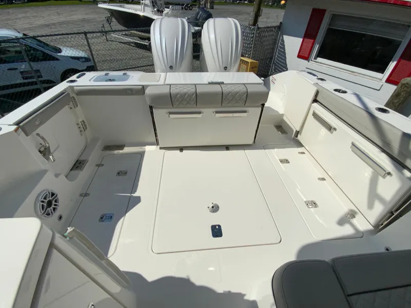 Slide: The Image of 2025 Pursuit DC 306 Dual Console boat interior with seating and storage compartments. - 13