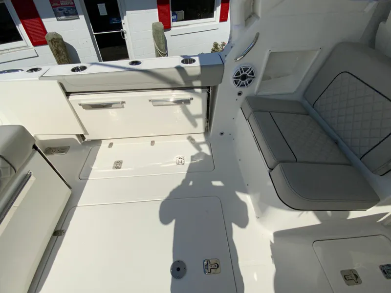Slide: The Image of Interior of 2025 Pursuit DC 306 Dual Console boat with seating and storage compartments. - 14