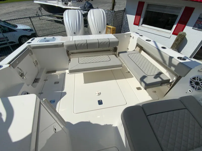 Slide: The Image of 2025 Pursuit DC 306 Dual Console boat interior with seating and storage compartments. - 15