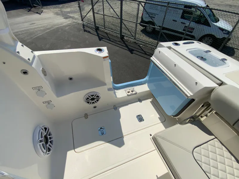 Slide: The Image of 2025 Pursuit DC 306 Dual Console boat interior with storage compartments and speakers. - 16
