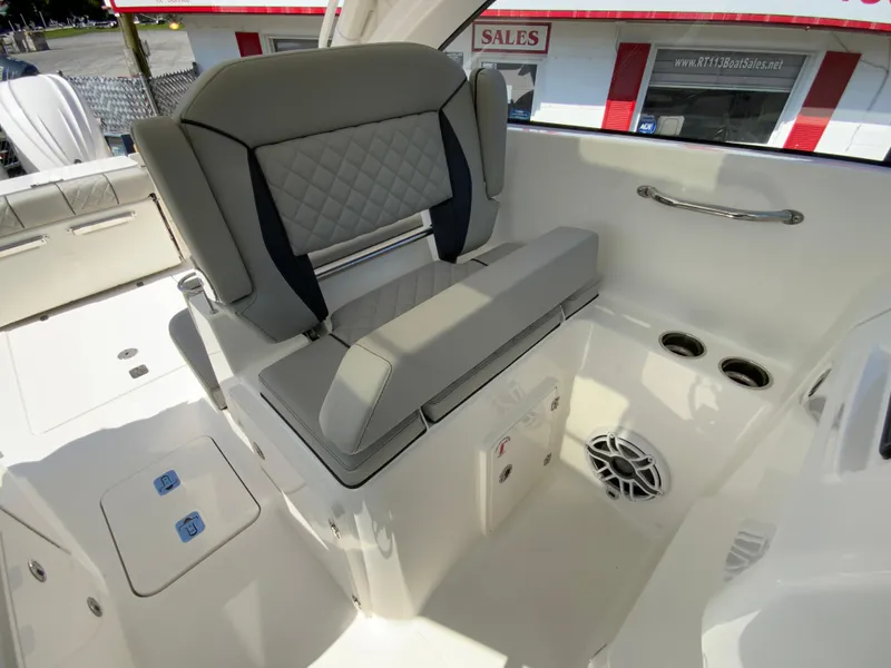 Slide: The Image of 2025 Pursuit DC 306 Dual Console boat interior with cushioned seating and storage. - 21