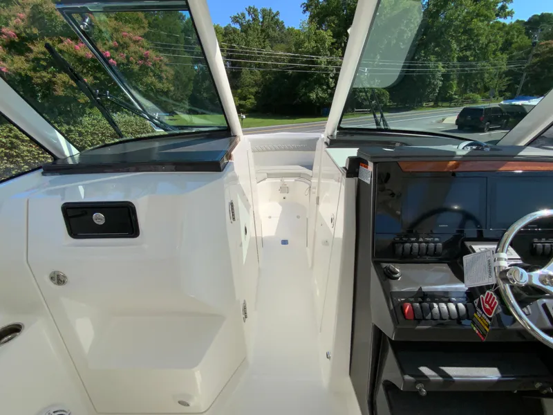 Slide: The Image of 2025 Pursuit DC 306 Dual Console boat interior with helm and seating area. - 23