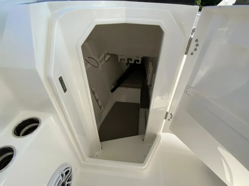 Slide: The Image of 2025 Pursuit DC 306 Dual Console cabin interior with seating and storage. - 24
