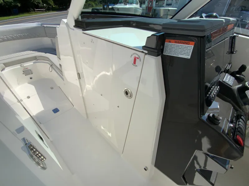 Slide: The Image of 2025 Pursuit DC 306 Dual Console boat interior, featuring seating and control panel. - 25