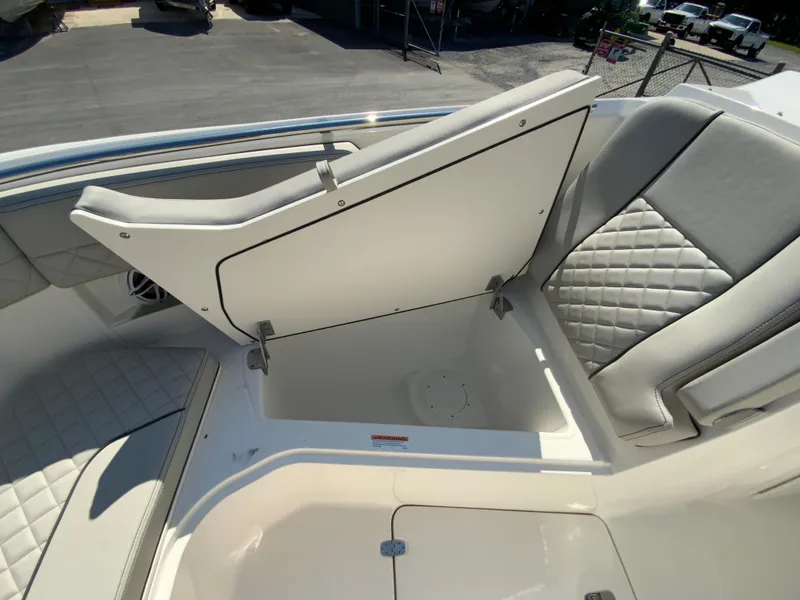 Slide: The Image of 2025 Pursuit DC 306 Dual Console boat with open storage compartment. - 30