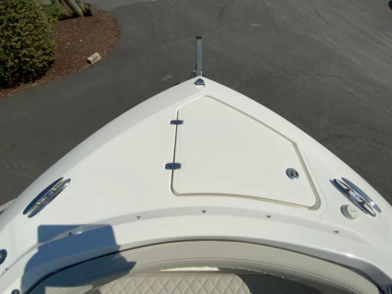 Slide: The Image of Bow of 2025 Pursuit DC 306 Dual Console boat with storage hatch. - 31