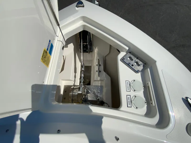 Slide: The Image of 2025 Pursuit DC 306 Dual Console anchor locker and windlass system. - 32