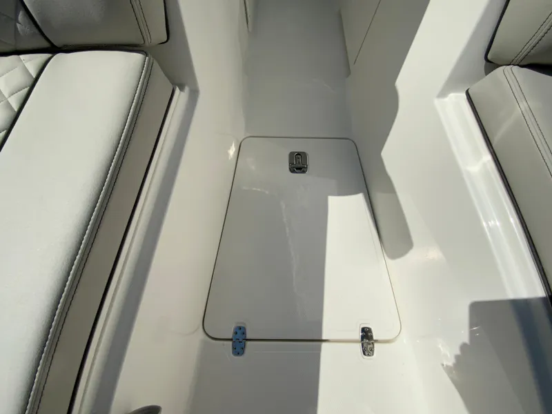 Slide: The Image of 2025 Pursuit DC 306 Dual Console boat interior with storage compartment. - 35