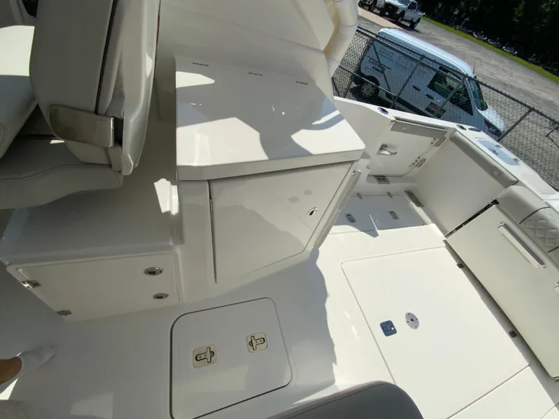 Slide: The Image of 2025 Pursuit DC 306 Dual Console boat interior, featuring storage compartments and seating. - 38