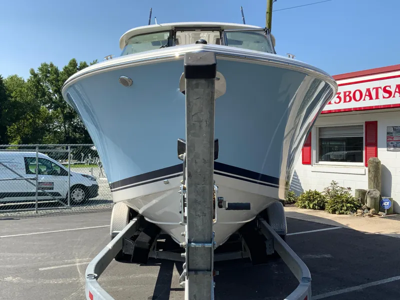 Slide: The Image of 2025 Pursuit DC 306 Dual Console boat on trailer at dealership. - 4