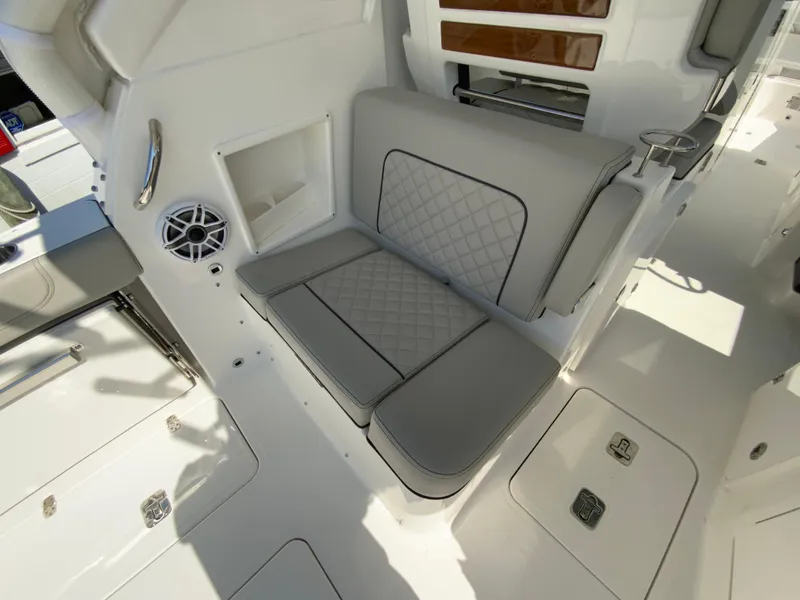 Slide: The Image of 2025 Pursuit DC 306 Dual Console interior seating area with quilted cushions. - 40