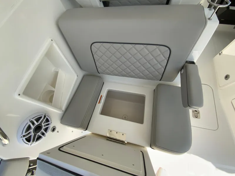 Slide: The Image of 2025 Pursuit DC 306 Dual Console interior seating and storage compartments. - 42