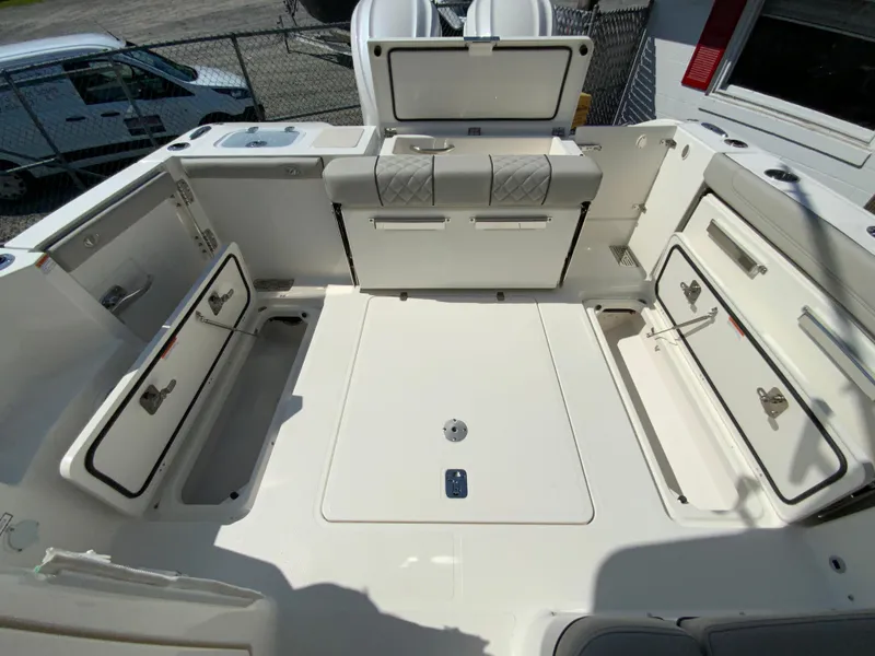 Slide: The Image of 2025 Pursuit DC 306 Dual Console boat with open storage compartments. - 43