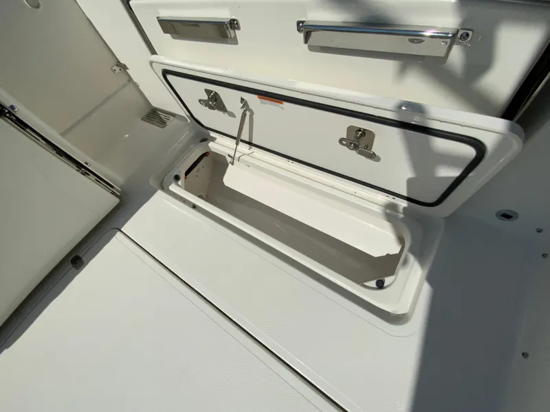 Slide: The Image of 2025 Pursuit DC 306 Dual Console storage compartment. - 44