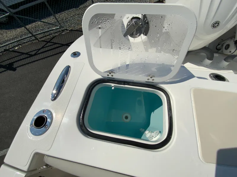 Slide: The Image of 2025 Pursuit DC 306 Dual Console livewell with open lid. - 48