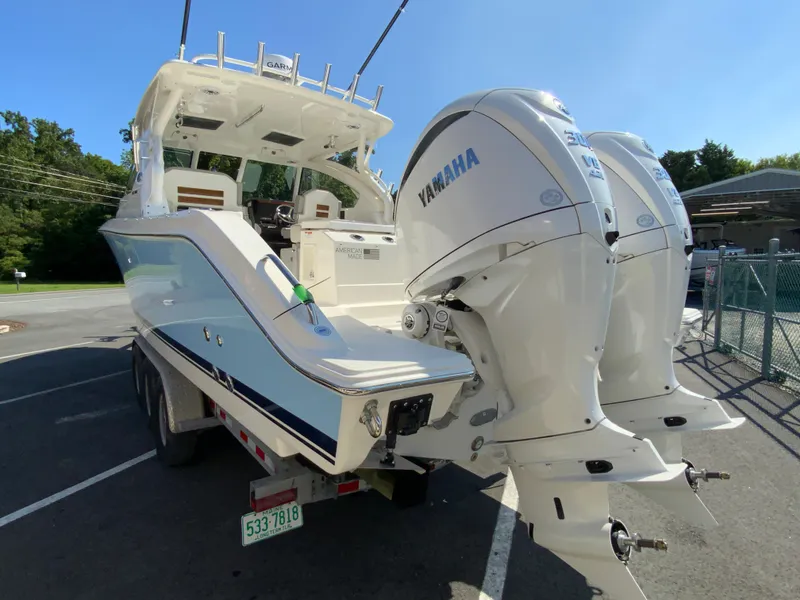 Slide: The Image of 2025 Pursuit DC 306 Dual Console boat with twin Yamaha engines on trailer. - 8