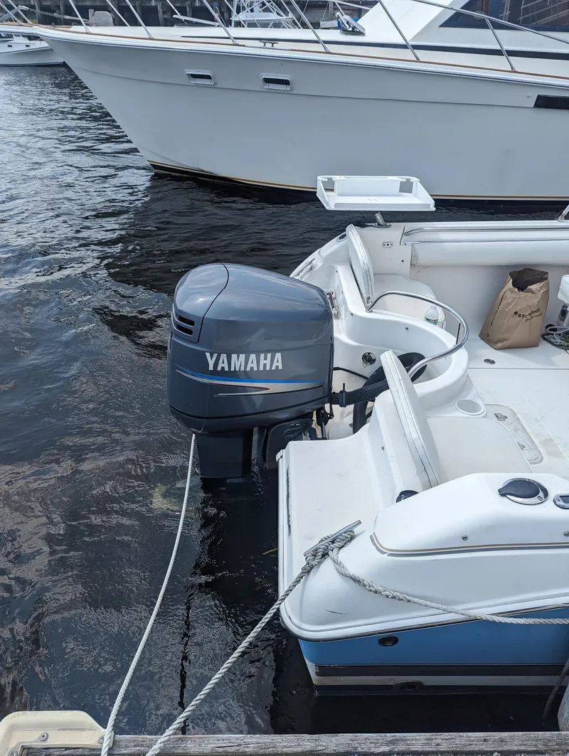 Slide: The Image of 2004 Wellcraft 220 Sportsman DC with Yamaha outboard motor docked. - 4