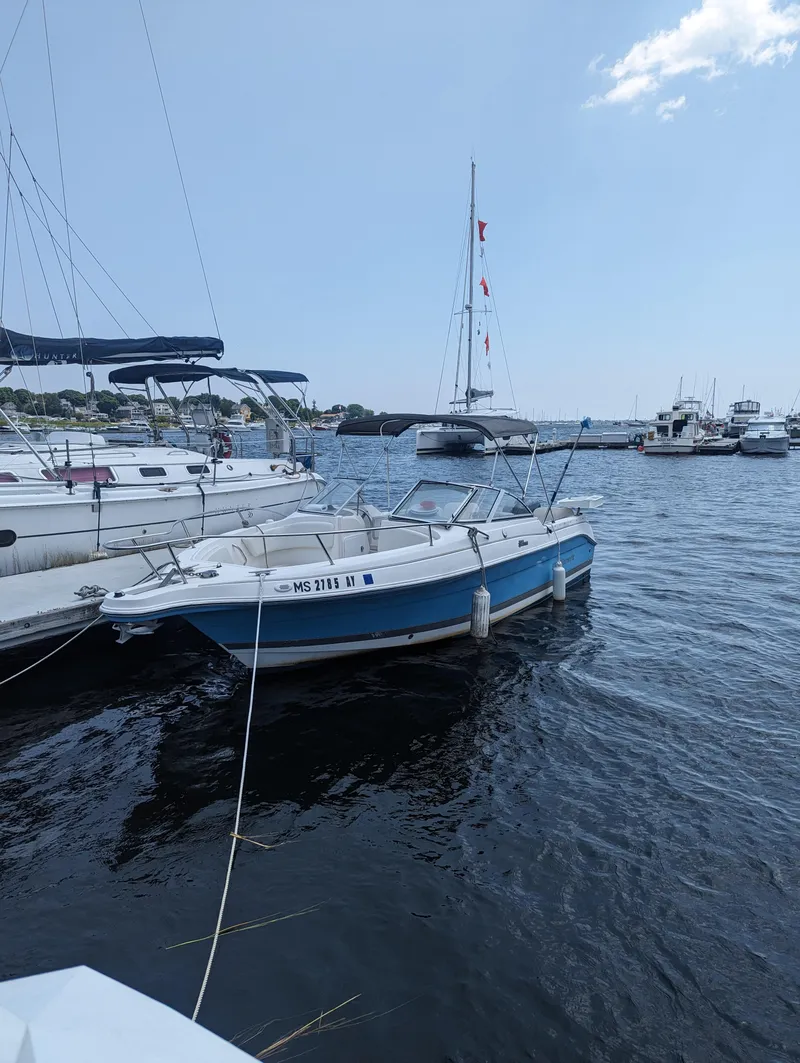 Slide: The Image of 2004 Wellcraft 220 Sportsman DC boat docked in a marina. - 6