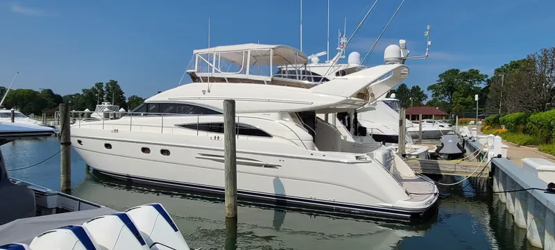 Slide: The Image of 2006 Viking Sport Cruisers 61 Flybridge yacht docked at a marina. - 0