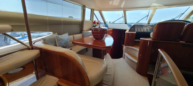 Slide: The Image of Luxurious interior of 2006 Viking Sport Cruisers 61 Flybridge yacht with elegant seating and dining area. - 14
