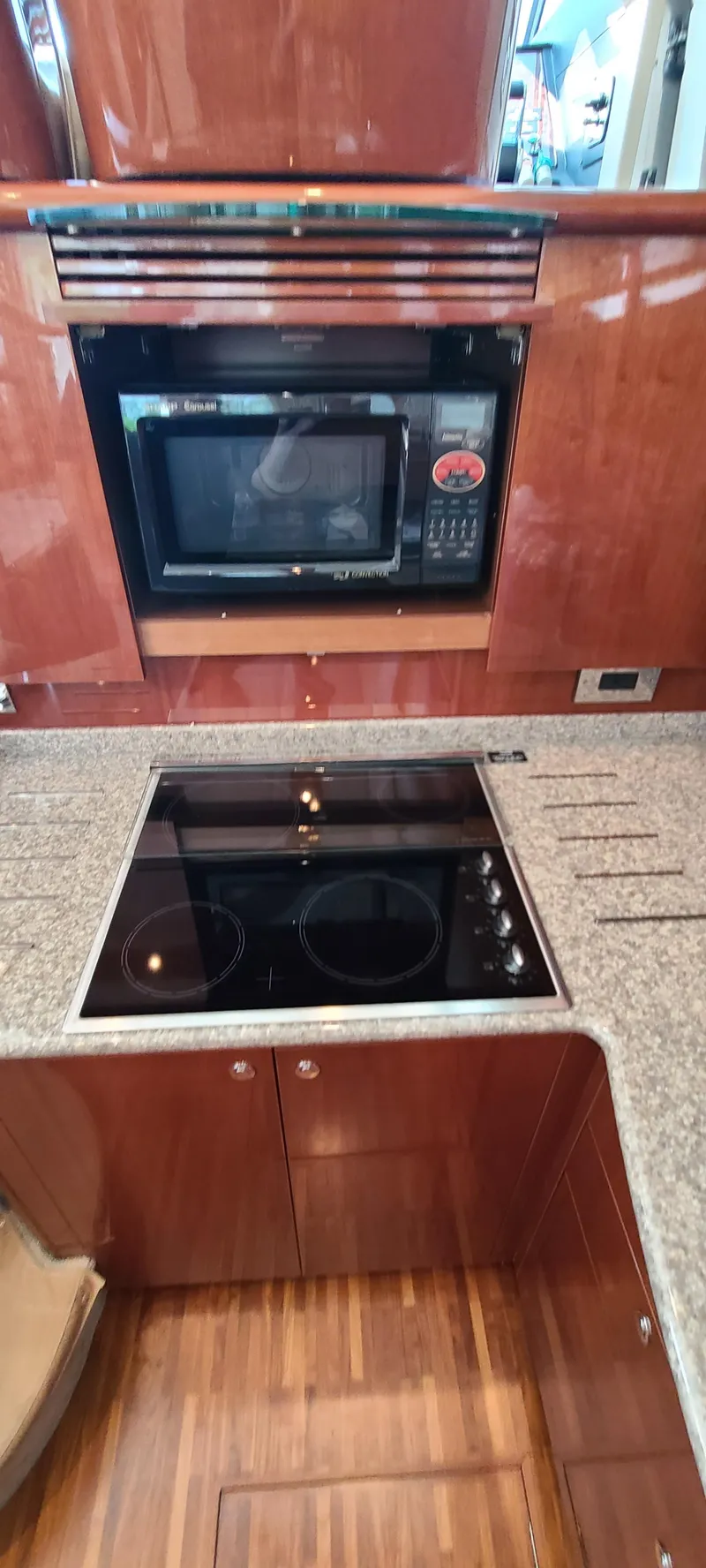 Slide: The Image of Galley kitchen in 2006 Viking Sport Cruisers 61 Flybridge with microwave and stovetop. - 17