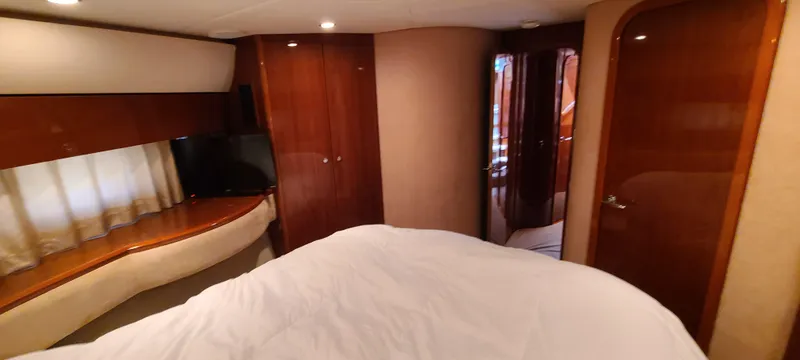 Slide: The Image of Luxurious bedroom interior of 2006 Viking Sport Cruisers 61 Flybridge yacht with wooden cabinetry. - 19