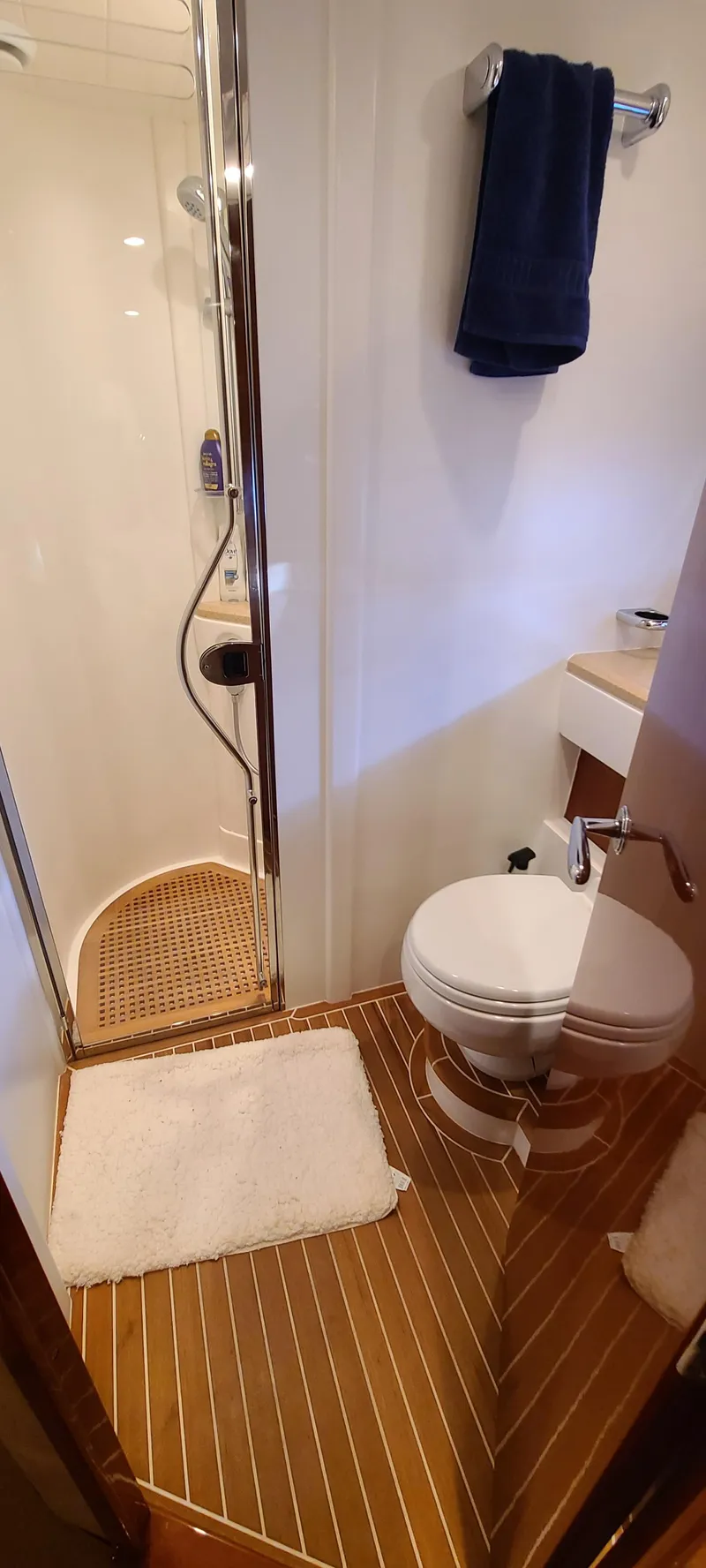 Slide: The Image of Bathroom of 2006 Viking Sport Cruisers 61 Flybridge with shower, toilet, and wooden flooring. - 20