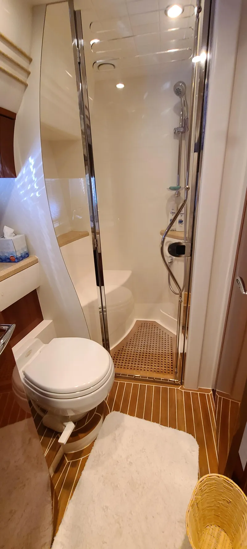 Slide: The Image of Bathroom of 2006 Viking Sport Cruisers 61 Flybridge with shower, toilet, and wooden flooring. - 23