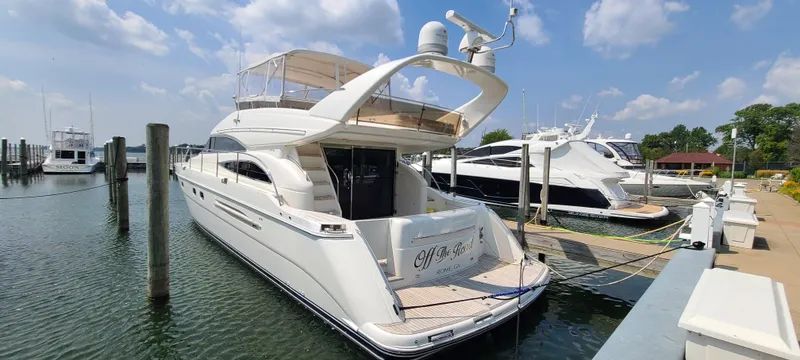 Slide: The Image of 2006 Viking Sport Cruisers 61 Flybridge yacht docked at a marina on a sunny day. - 5
