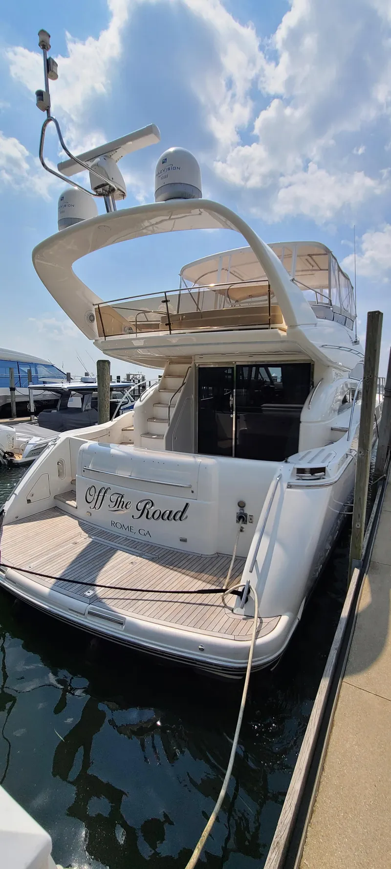 Slide: The Image of 2006 Viking Sport Cruisers 61 Flybridge yacht docked, rear view with Off The Road name. - 7