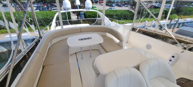 Slide: The Image of 2006 Viking Sport Cruisers 61 Flybridge with spacious seating and table on the upper deck. - 9