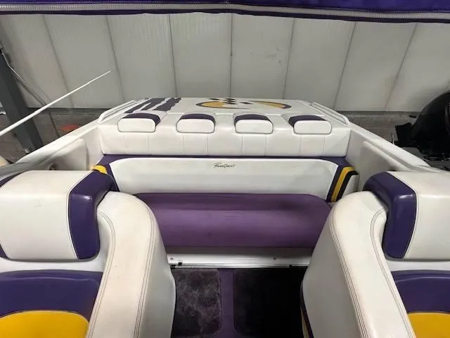Slide: The Image of Interior of a 2004 Powerquest 340 Vyper boat with purple and white seating. - 12