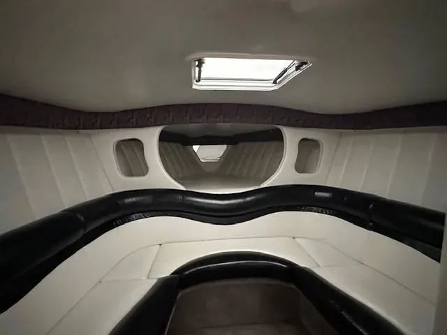Slide: The Image of Interior cabin of 2004 Powerquest 340 Vyper boat with white and black seating. - 15