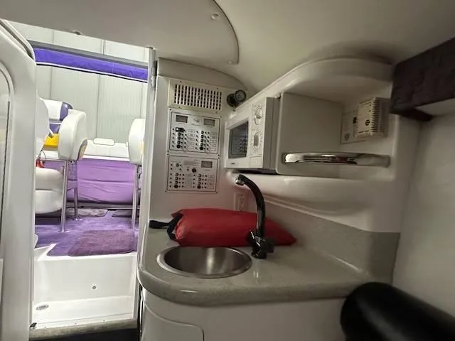 Slide: The Image of 2004 Powerquest 340 Vyper boat interior with kitchenette and seating area. - 17