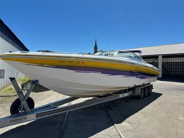 Slide: The Image of 2004 Powerquest 340 Vyper boat on a Loadmaster trailer, parked outdoors. - 3