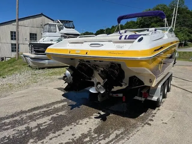 Slide: The Image of 2004 Powerquest 340 Vyper boat on trailer, yellow and white, docked near a building. - 6