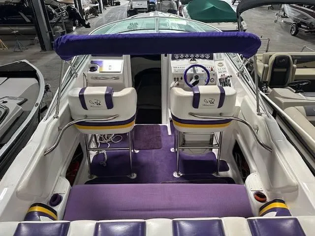Slide: The Image of 2004 Powerquest 340 Vyper boat interior with purple and white seating and dashboard. - 9