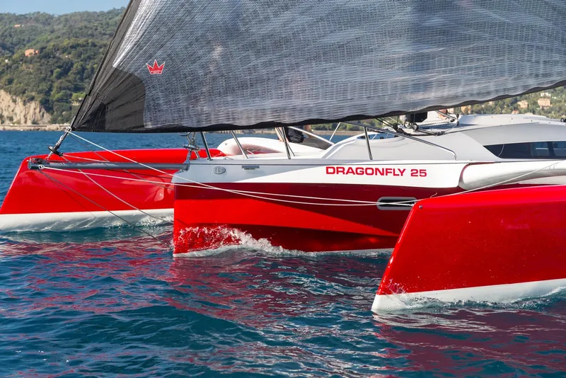 The Image of Red Dragonfly 25 trimaran sailing on blue water, 2026 model. - 0