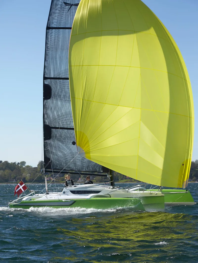 Slide: The Image of Sailing yacht Dragonfly 25 (2026) with bright yellow sail on open water. - 2