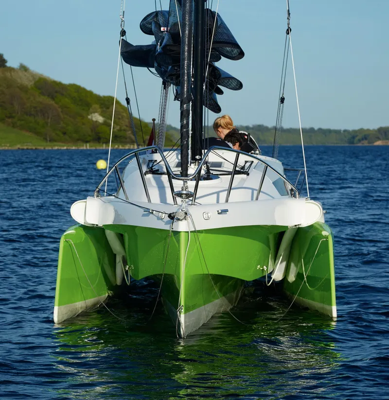 Slide: The Image of Green Dragonfly 25 trimaran sailing on a calm lake, 2026 model. - 4