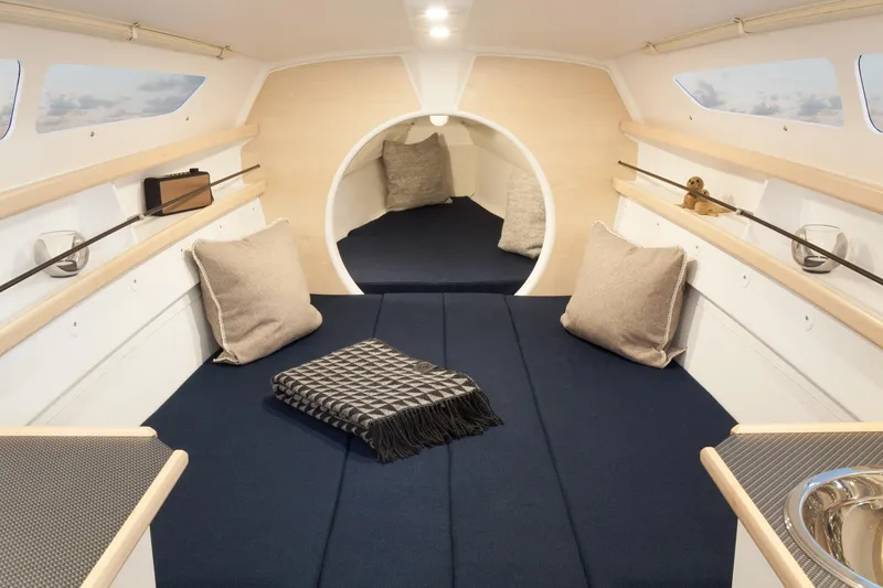 Slide: The Image of Cozy interior of 2026 Dragonfly 25 sailboat with cushions and blanket. - 6