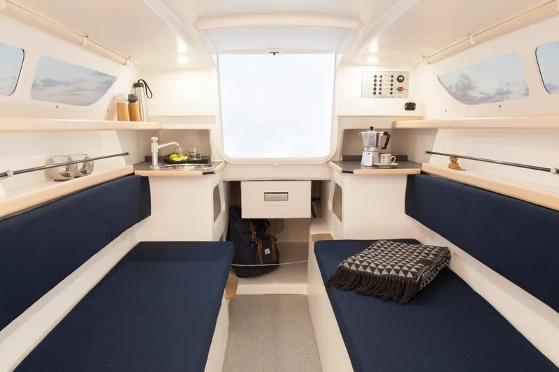 Slide: The Image of Interior of 2026 Dragonfly 25 sailboat with cozy seating and modern amenities. - 7