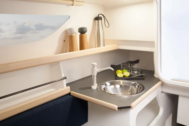 Slide: The Image of Compact kitchen area in 2026 Dragonfly 25 sailboat with sink and countertop accessories. - 8